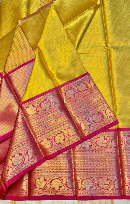 Attractive Kanjeevaram Gold saree with dark pink Zari weaving skirt border