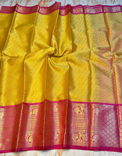Attractive Kanjeevaram Gold saree with dark pink Zari weaving skirt border