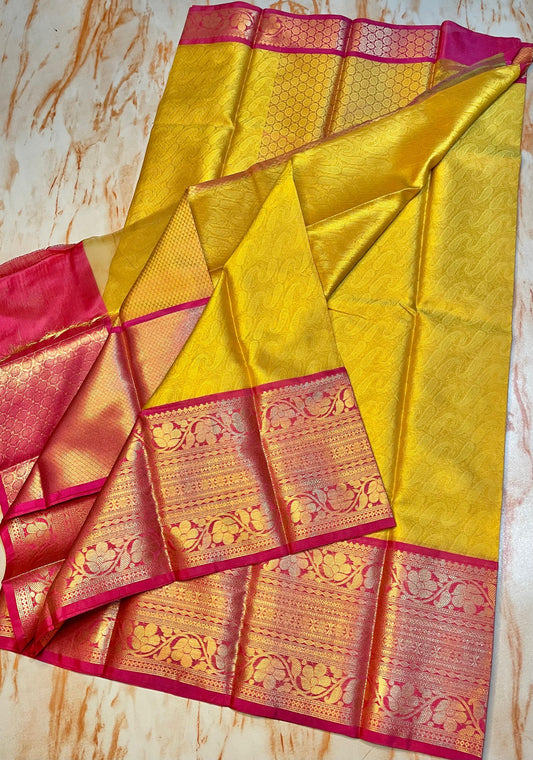 Attractive Kanjeevaram Gold saree with dark pink Zari weaving skirt border